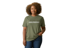 Load image into Gallery viewer, Woman wearing a green t-shirt with 'Shepherd' printed on it against a white background