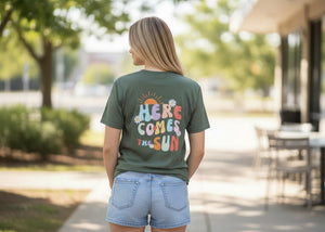 Person wearing a green t-shirt with colorful text outdoors